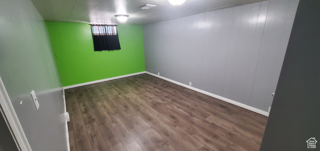 Finished basement featuring wood finished floors and baseboards