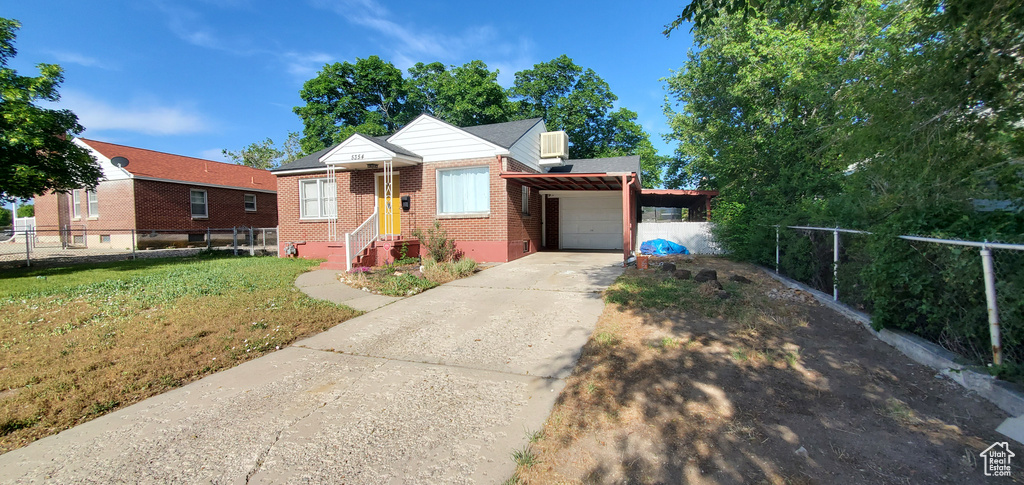 View of front of house with a garage, brick siding, and concrete driveway