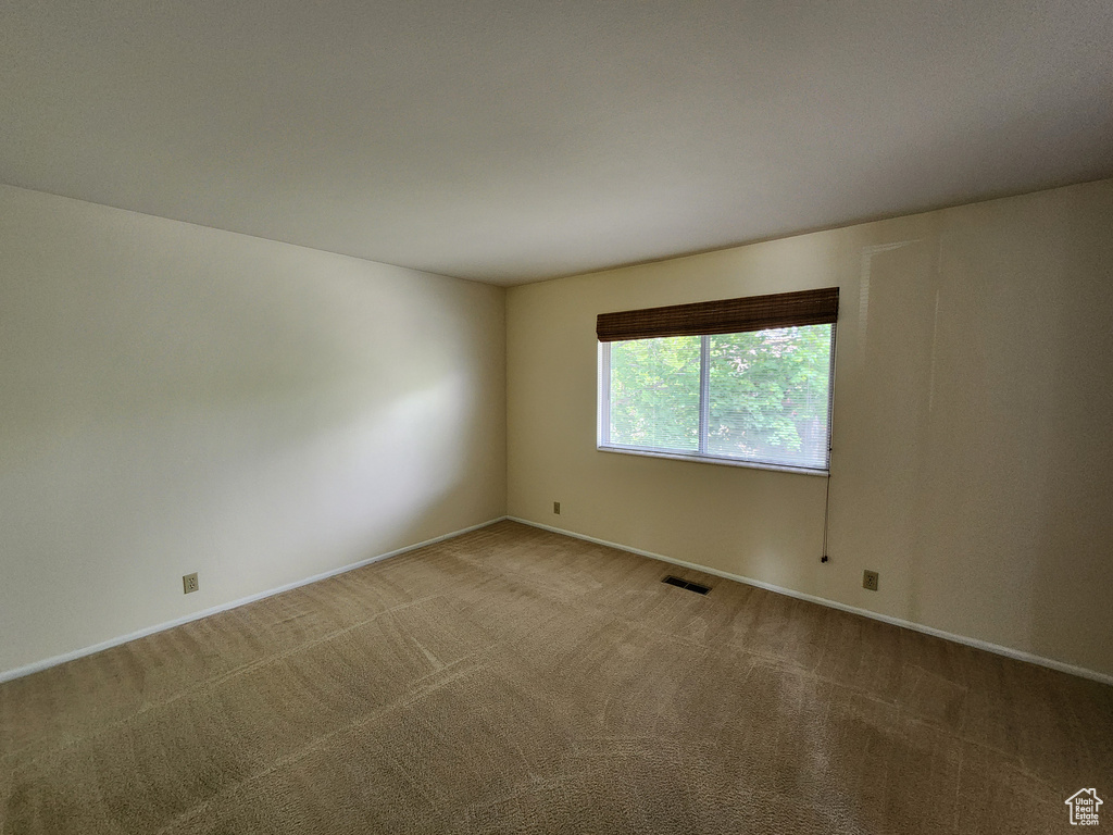 Empty room with carpet flooring and baseboards