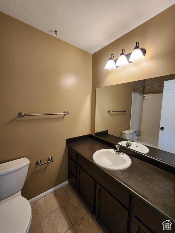 Bathroom with toilet, vanity, tile patterned floors, a shower with shower curtain, and baseboards