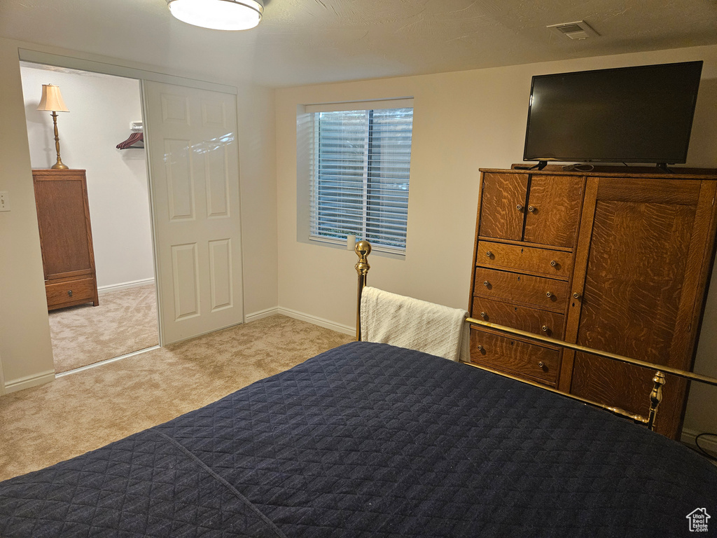 Bedroom with carpet floors and baseboards