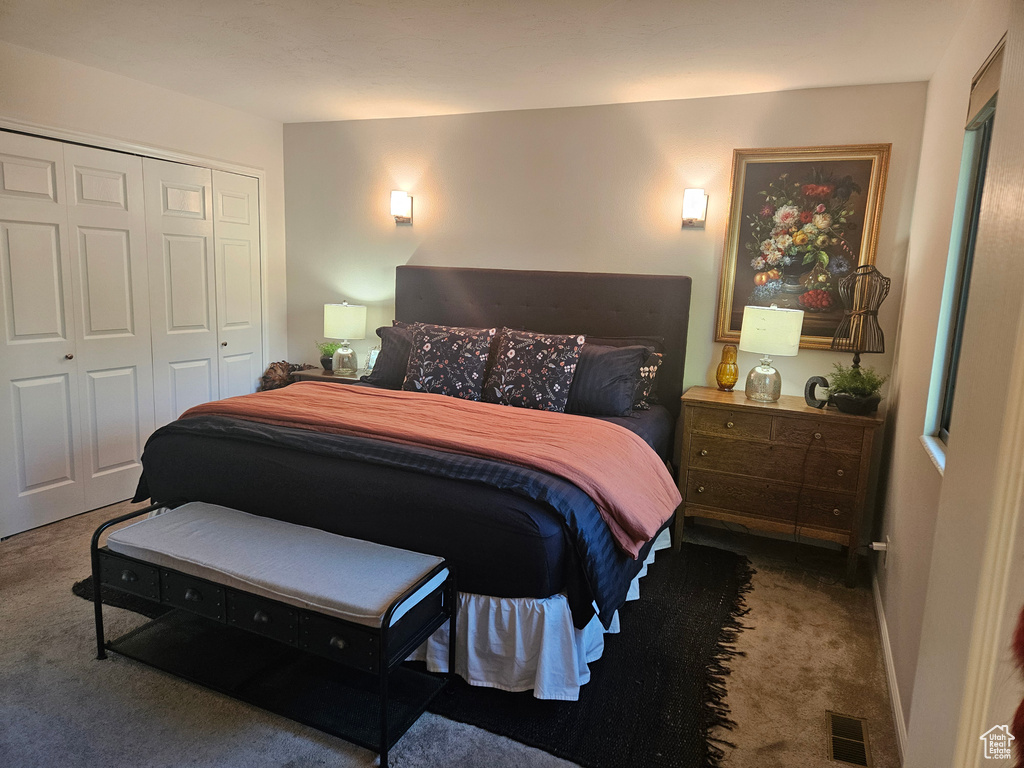 Carpeted bedroom featuring a closet