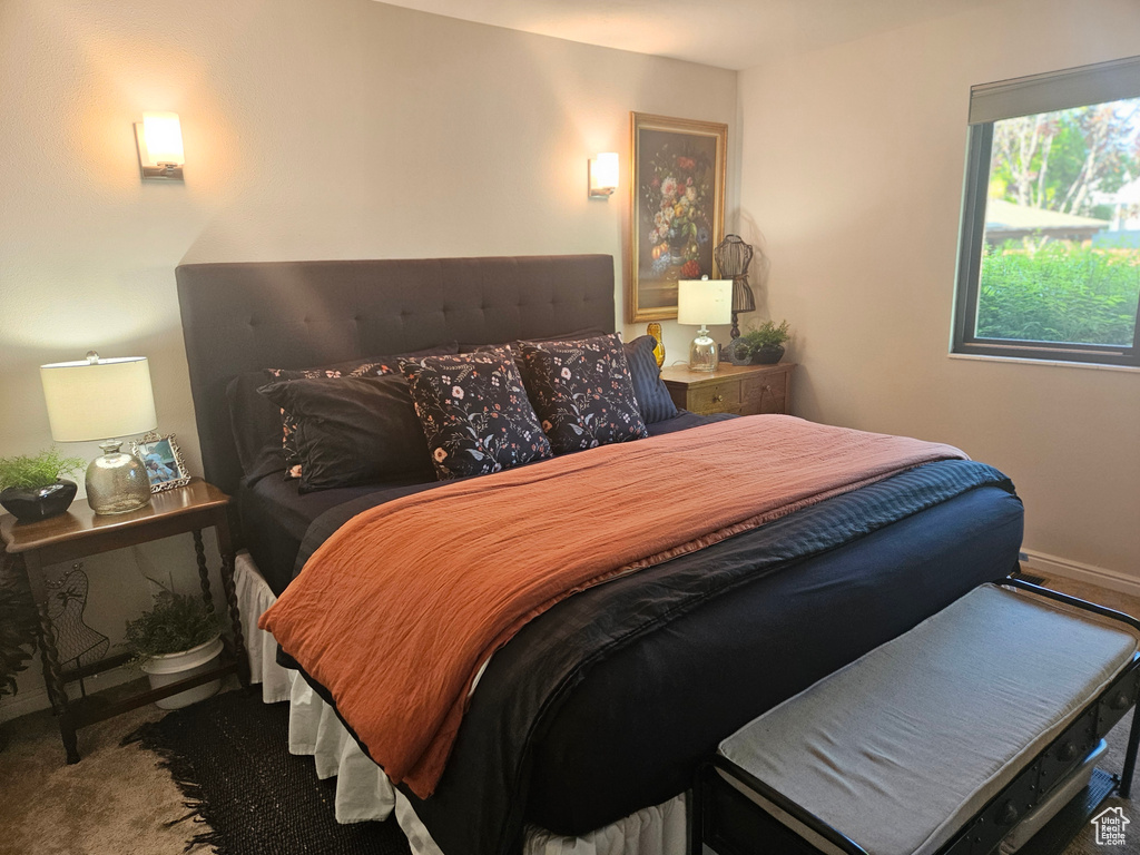 Carpeted bedroom featuring baseboards
