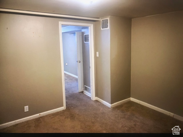 Carpeted spare room with baseboards