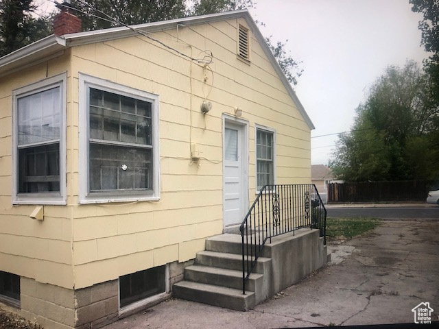 View of side of property with a chimney