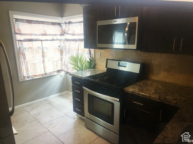 Kitchen with stainless steel appliances, plenty of natural light, and tasteful backsplash