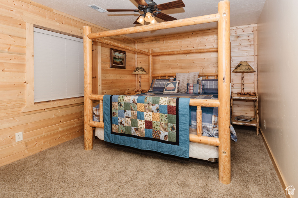 Bedroom featuring wooden walls and carpet