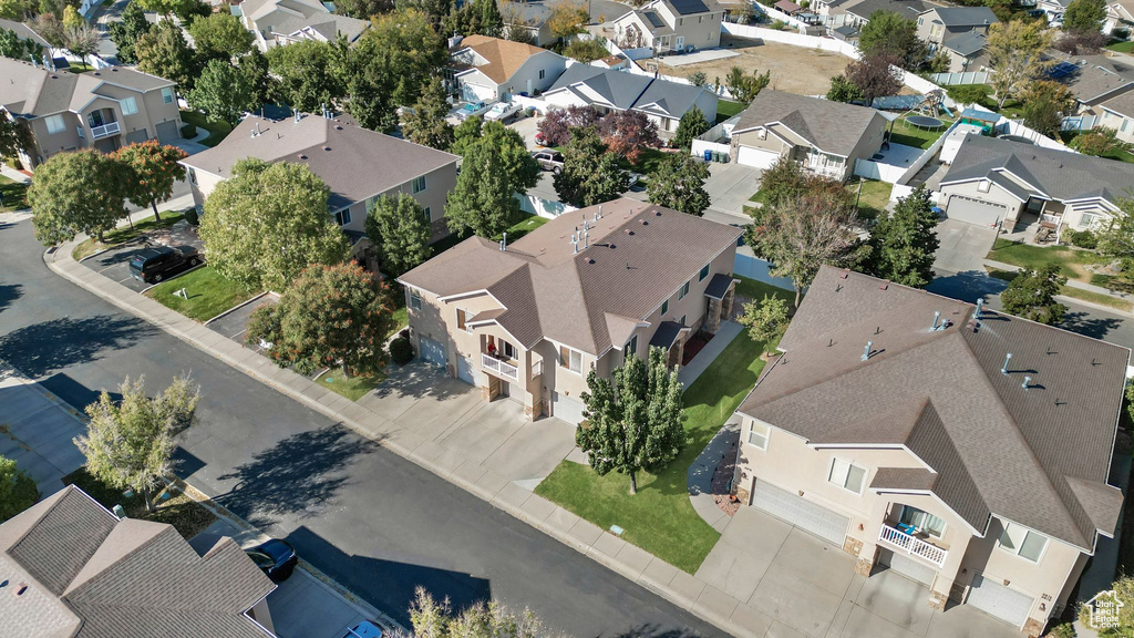 Aerial view of property and surrounding area with nearby suburban area