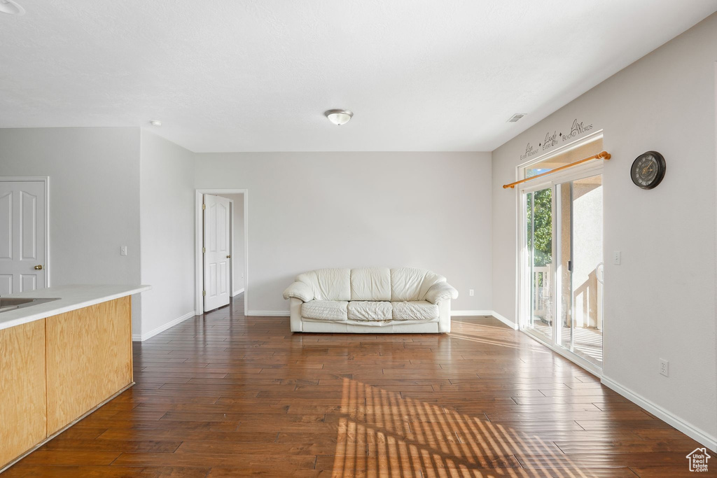 Living area featuring dark wood finished floors and baseboards