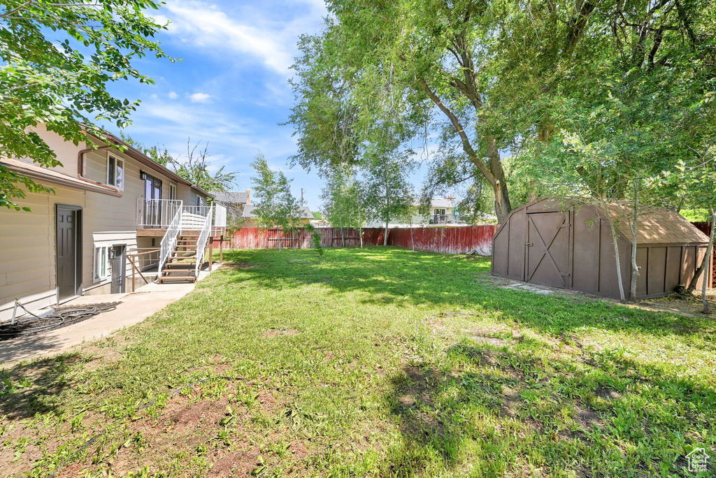 View of yard featuring stairway and a wooden deck