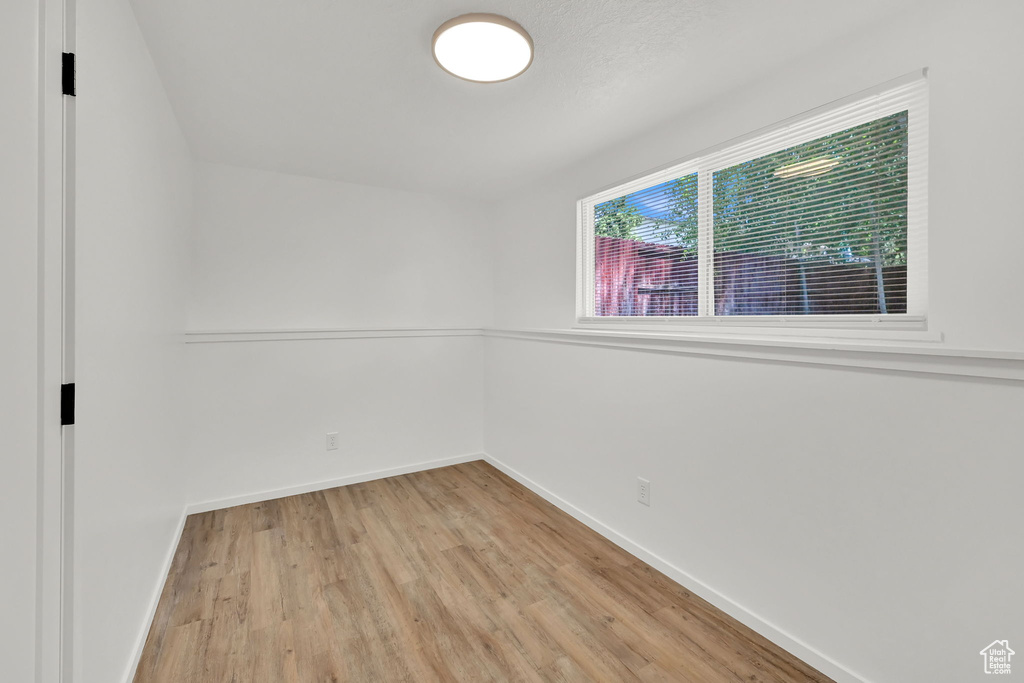 Unfurnished room featuring light wood-style flooring and baseboards