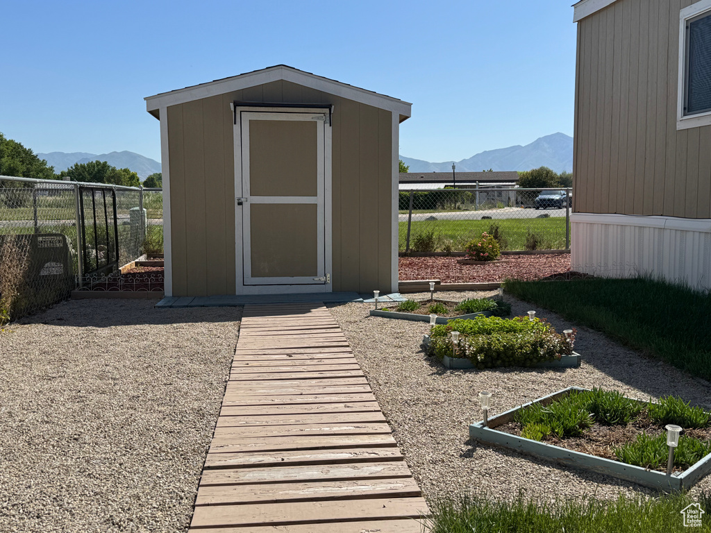 View of shed featuring a mountain view and a fenced backyard