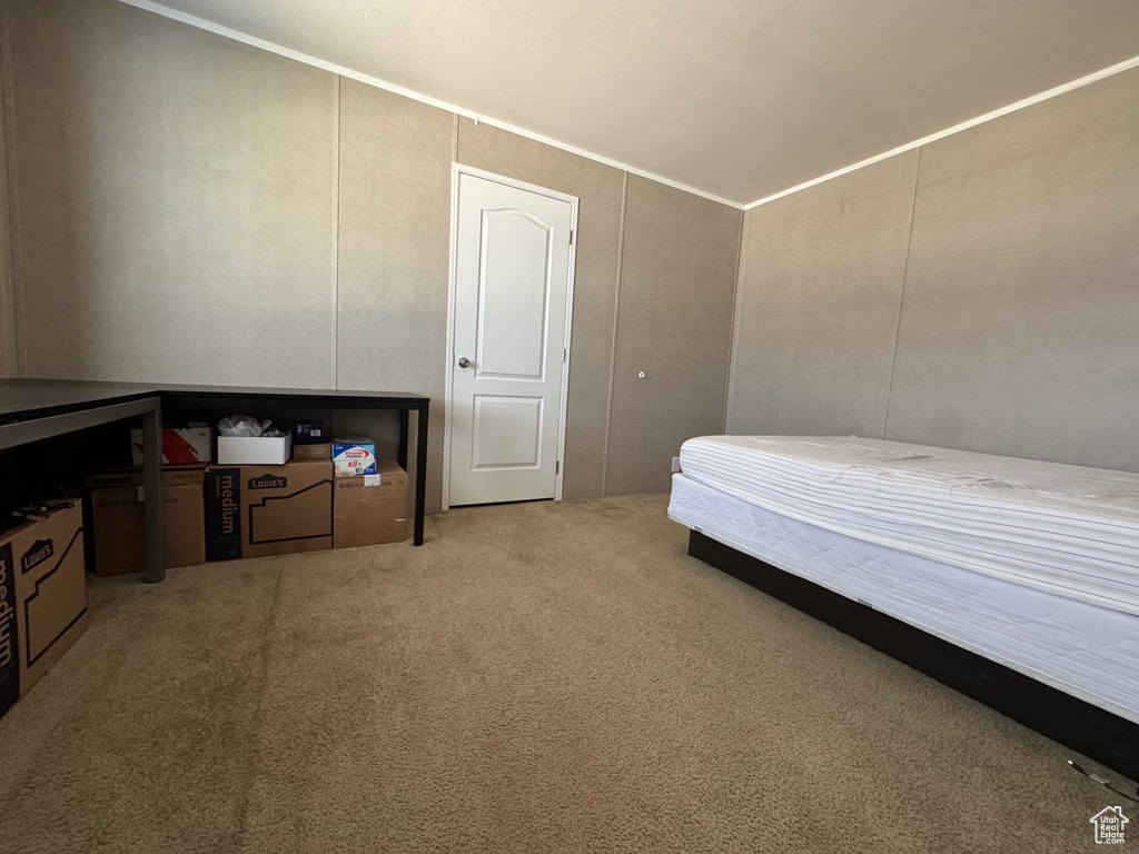 Carpeted bedroom featuring crown molding