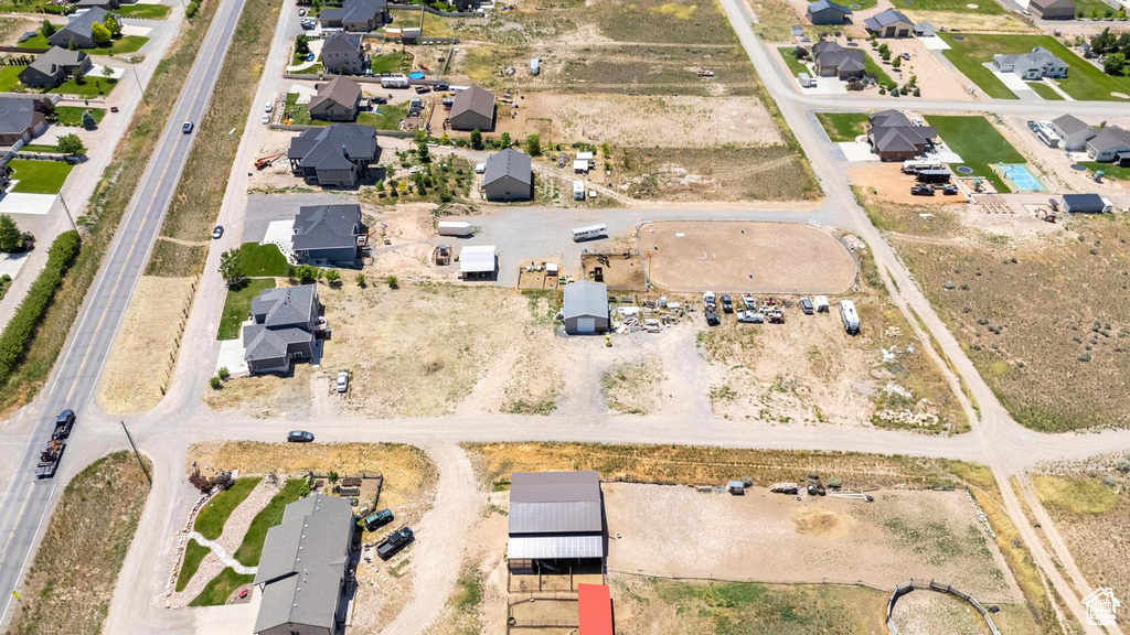 Aerial view of property and surrounding area featuring nearby suburban area