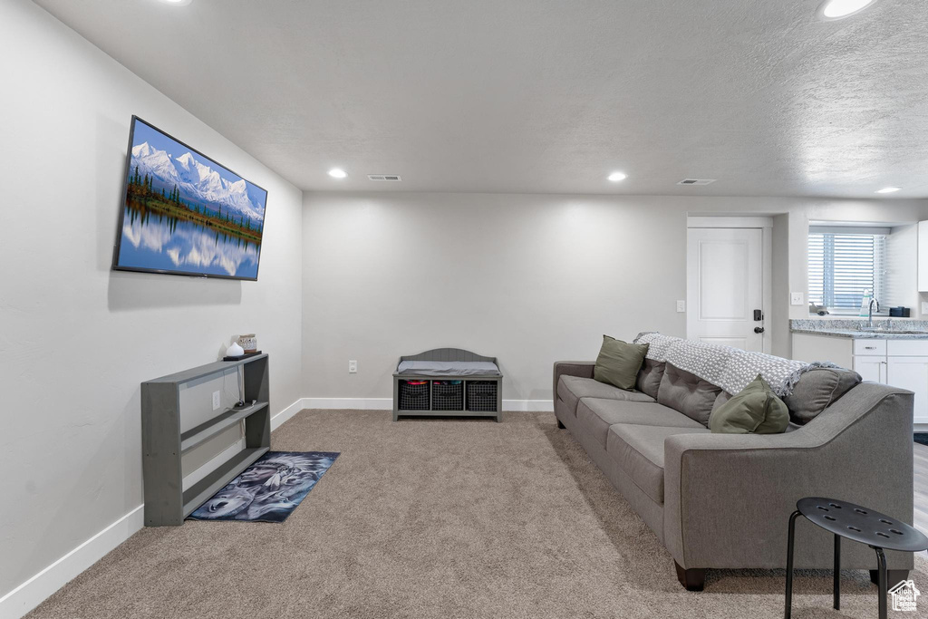 Living area featuring carpet, recessed lighting, and baseboards