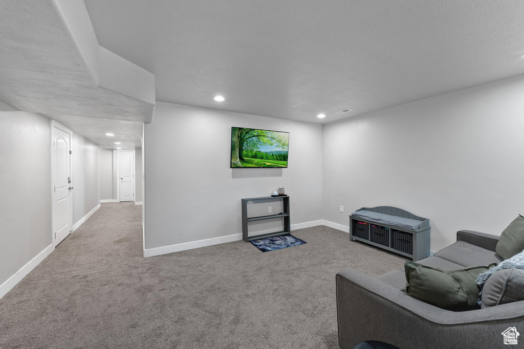 Unfurnished living room with carpet, recessed lighting, and baseboards