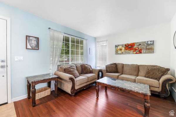 Living area with wood finished floors and baseboards