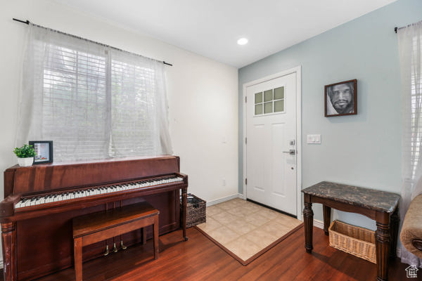 Entryway featuring wood finished floors, recessed lighting, and baseboards