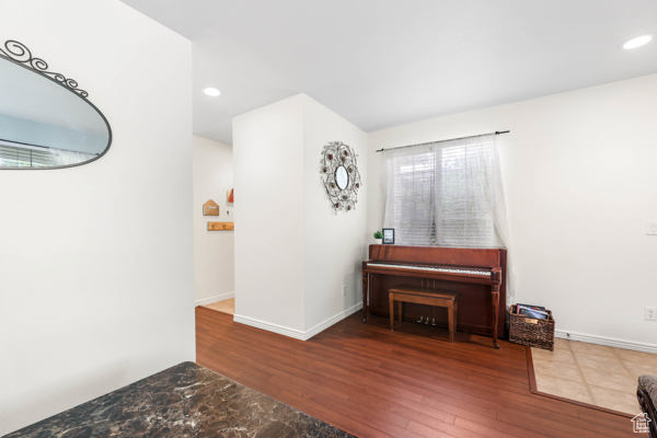 Sitting room with wood finished floors, recessed lighting, and baseboards