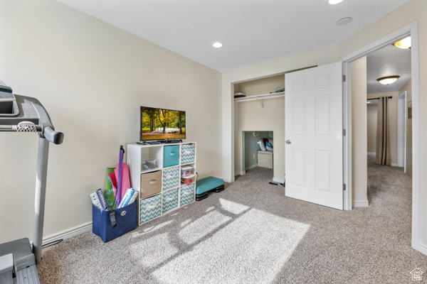 Carpeted bedroom featuring recessed lighting, a closet, and baseboards