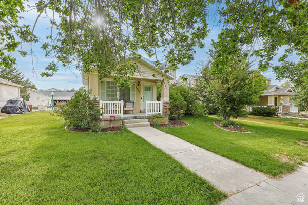 Bungalow with a porch and a front yard