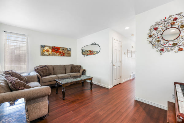 Living area featuring wood finished floors, baseboards, and recessed lighting