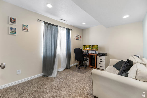Office space with carpet floors, baseboards, and recessed lighting