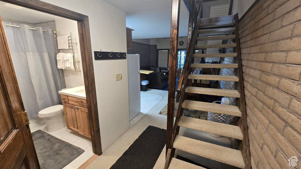 Staircase featuring tile patterned flooring