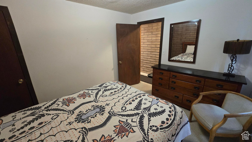 Carpeted bedroom featuring a textured ceiling