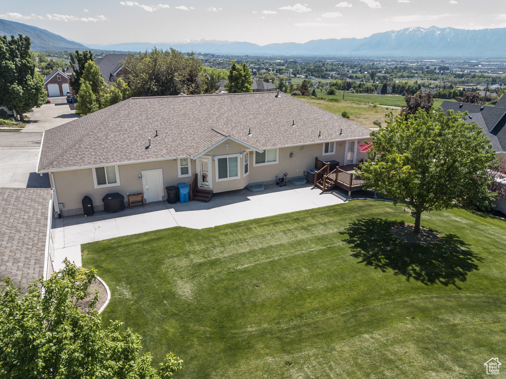 Aerial view of property and surrounding area featuring mountains