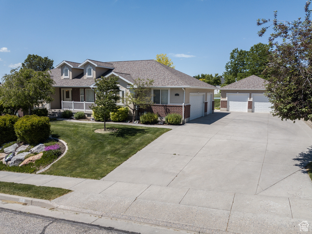 View of front of property with a front lawn and brick siding