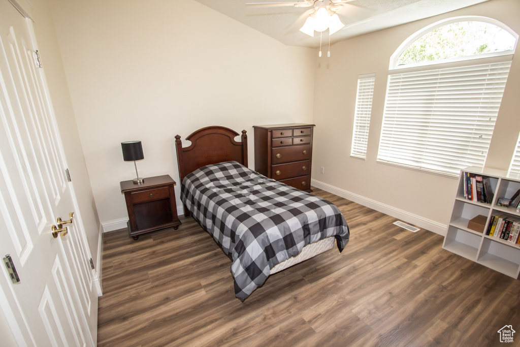 Bedroom featuring wood finished floors, baseboards, and a ceiling fan
