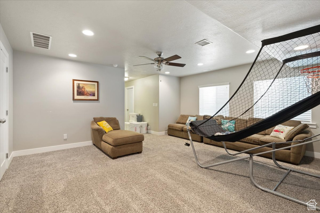 Living area with recessed lighting, ceiling fan, baseboards, and carpet floors