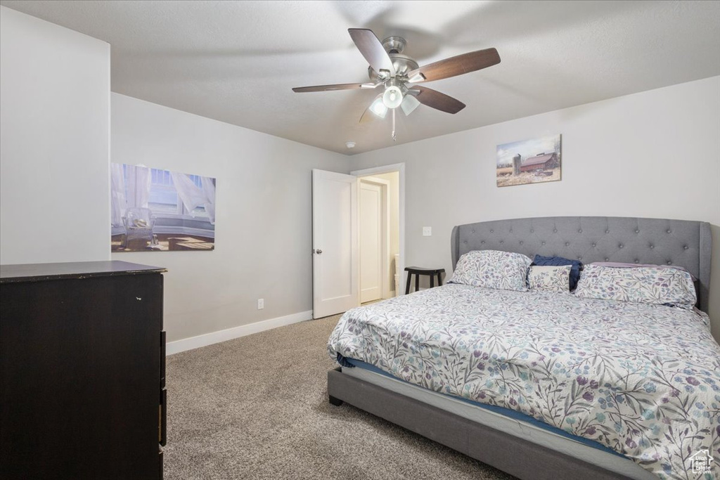 Bedroom with carpet floors, baseboards, and a ceiling fan