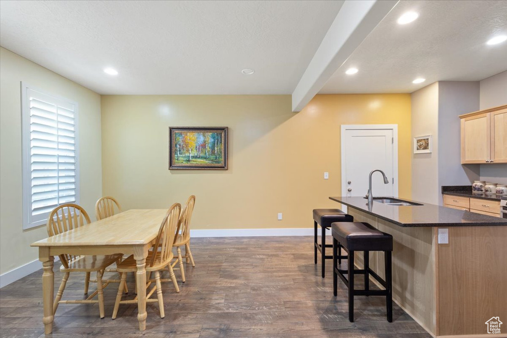 Dining space with baseboards, recessed lighting, and dark wood-style floors