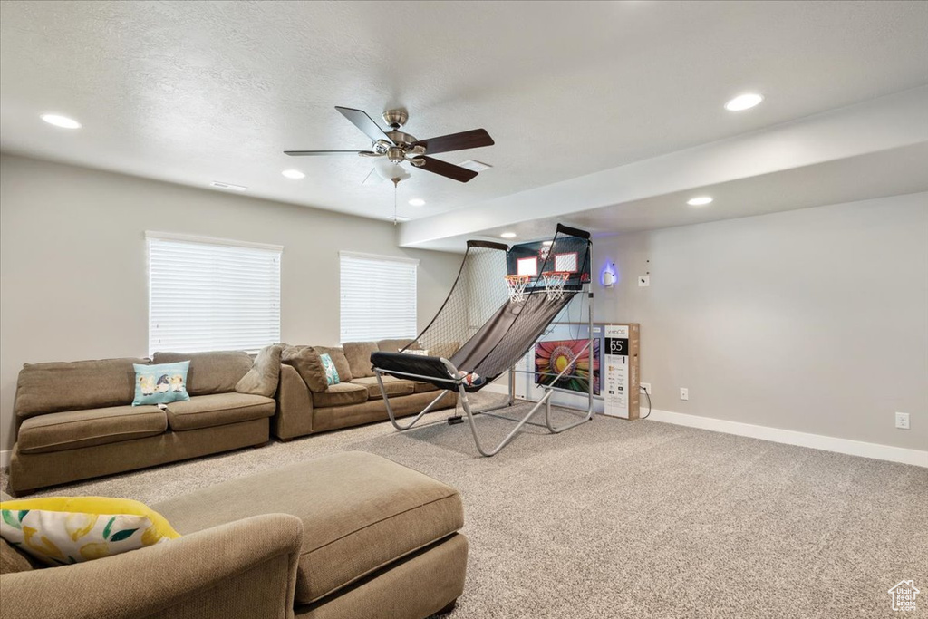 Living room with carpet floors, baseboards, ceiling fan, and recessed lighting