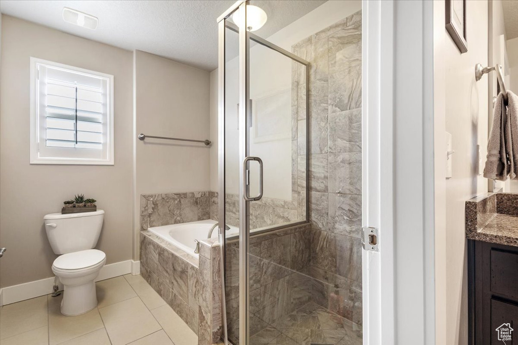 Full bathroom with toilet, a garden tub, vanity, and a stall shower