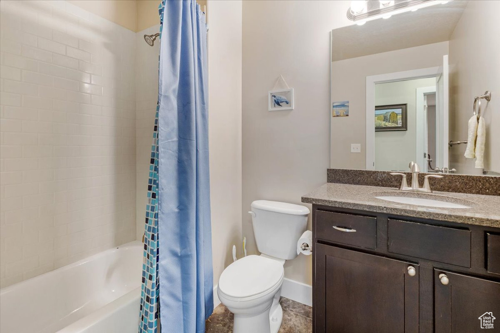 Full bath with vanity, toilet, and shower / bathtub combination with curtain