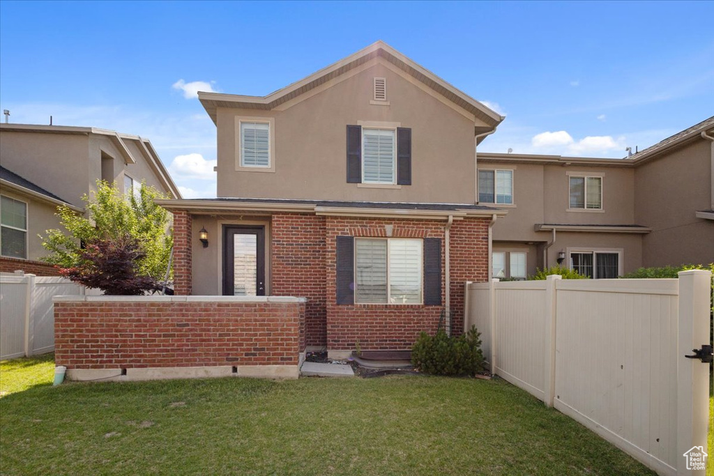Traditional home with stucco siding and brick siding