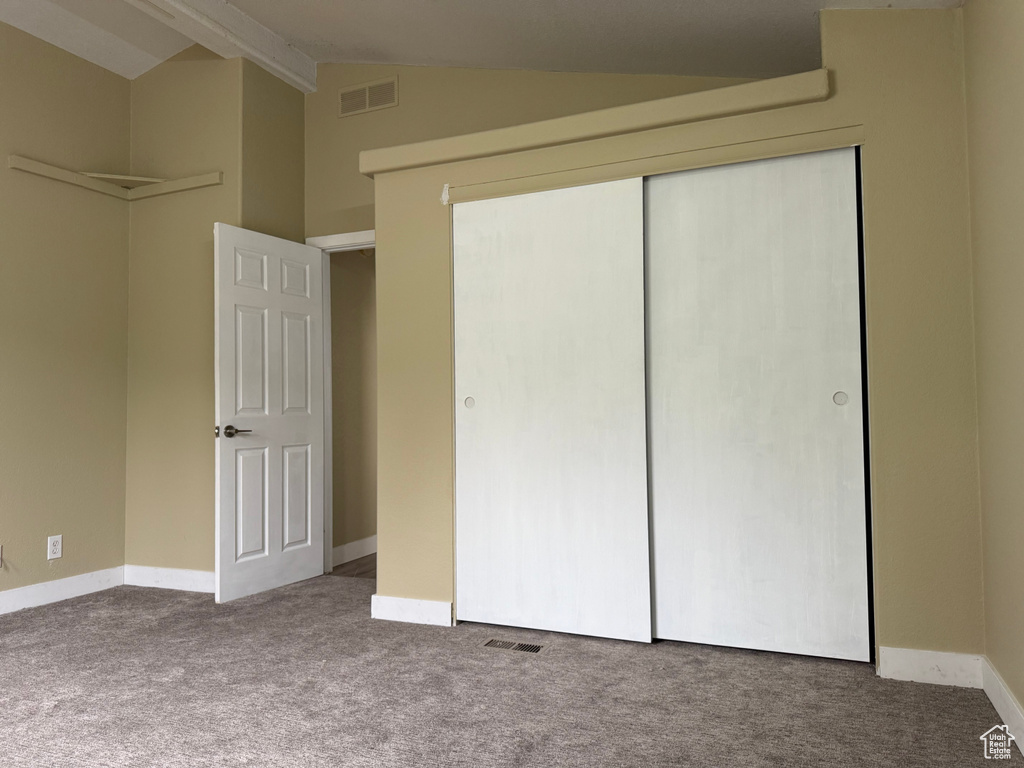 Unfurnished bedroom featuring carpet flooring, a closet, and baseboards