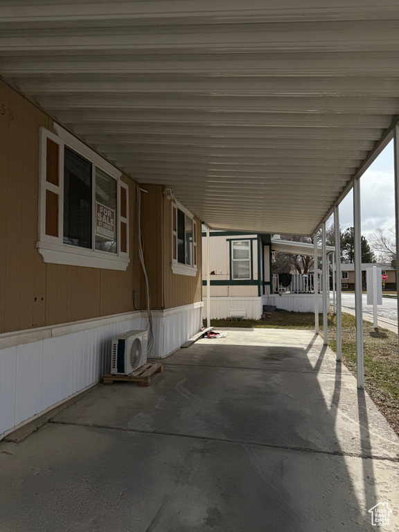 View of patio featuring ac unit and a carport