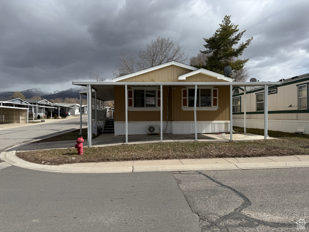 Manufactured / mobile home with a mountain view and a porch