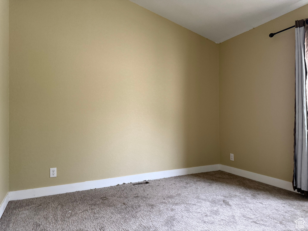 Spare room with carpet and baseboards