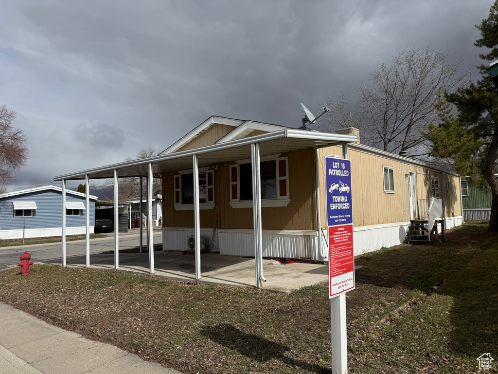 View of front facade featuring a carport and entry steps