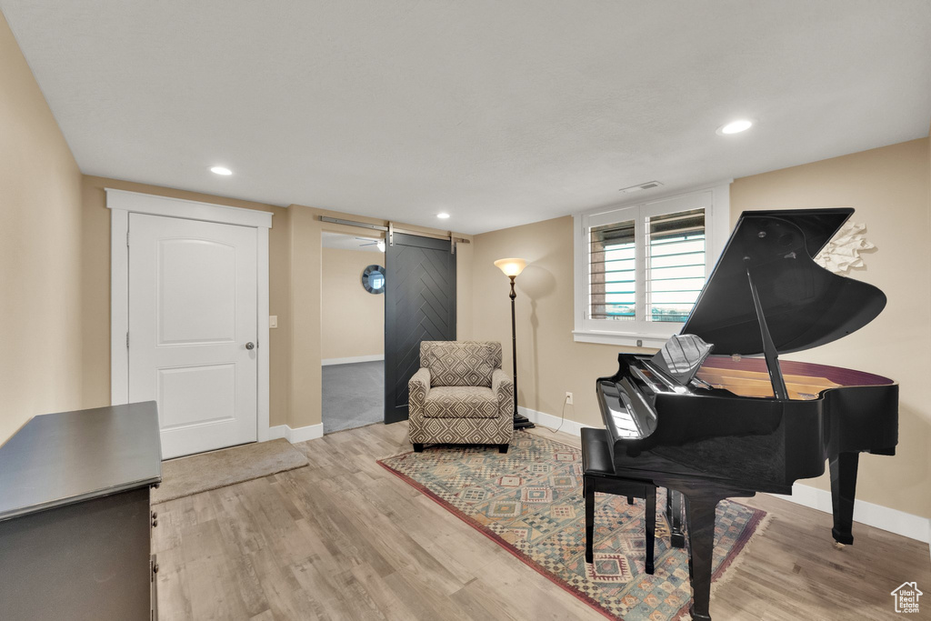 Living area featuring baseboards, wood finished floors, and recessed lighting