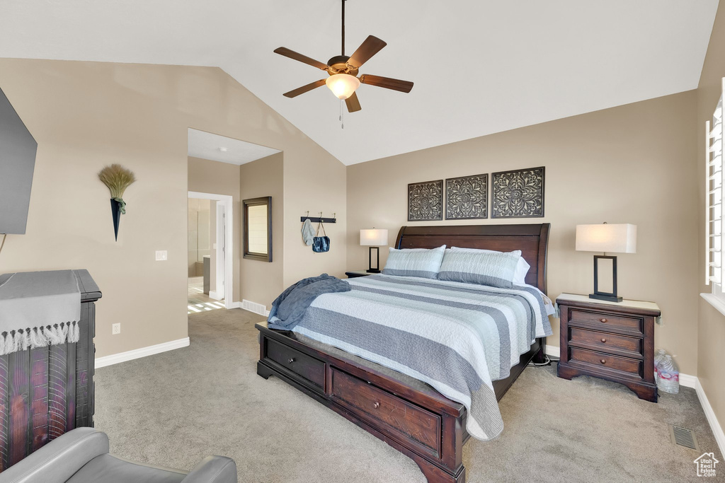 Carpeted bedroom with lofted ceiling, baseboards, and ceiling fan