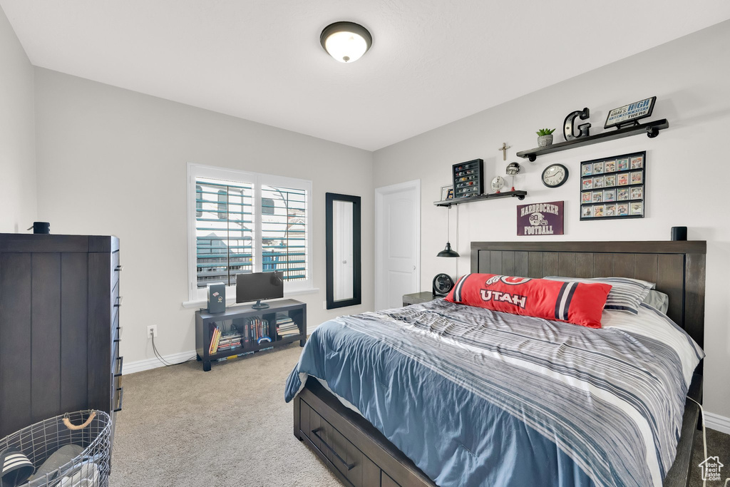 Bedroom featuring carpet flooring and baseboards