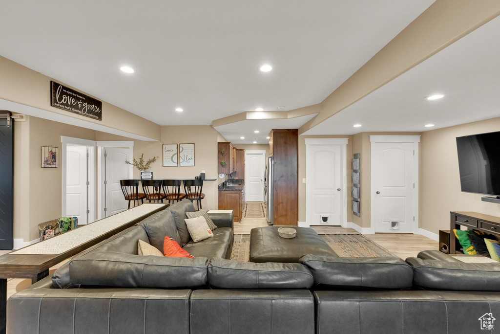 Living room featuring recessed lighting, light wood finished floors, and baseboards