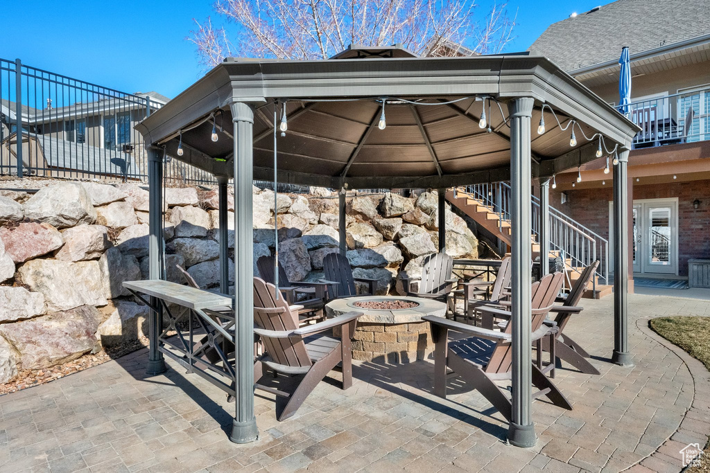 View of patio / terrace with a fire pit, stairs, and a gazebo