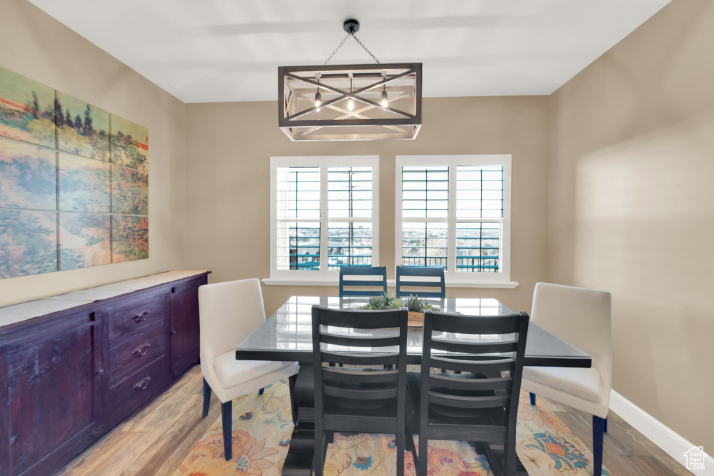 Dining area with healthy amount of natural light, light wood-type flooring, and baseboards